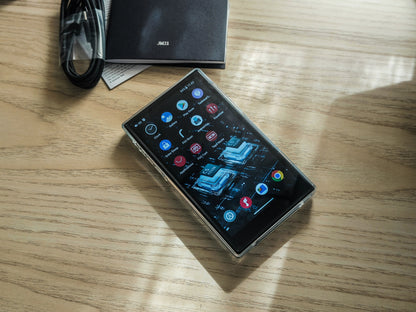 Reproductor de audio digital FIIO JM21 con Android 13 y Snapdragon 680, pantalla y controles visibles en la imagen.